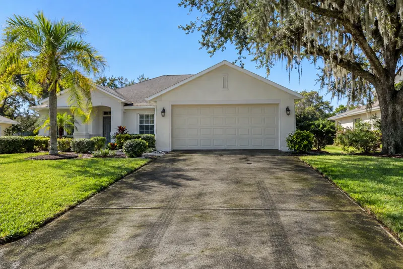 Before: a concrete driveway in front of a Florida home, dirty